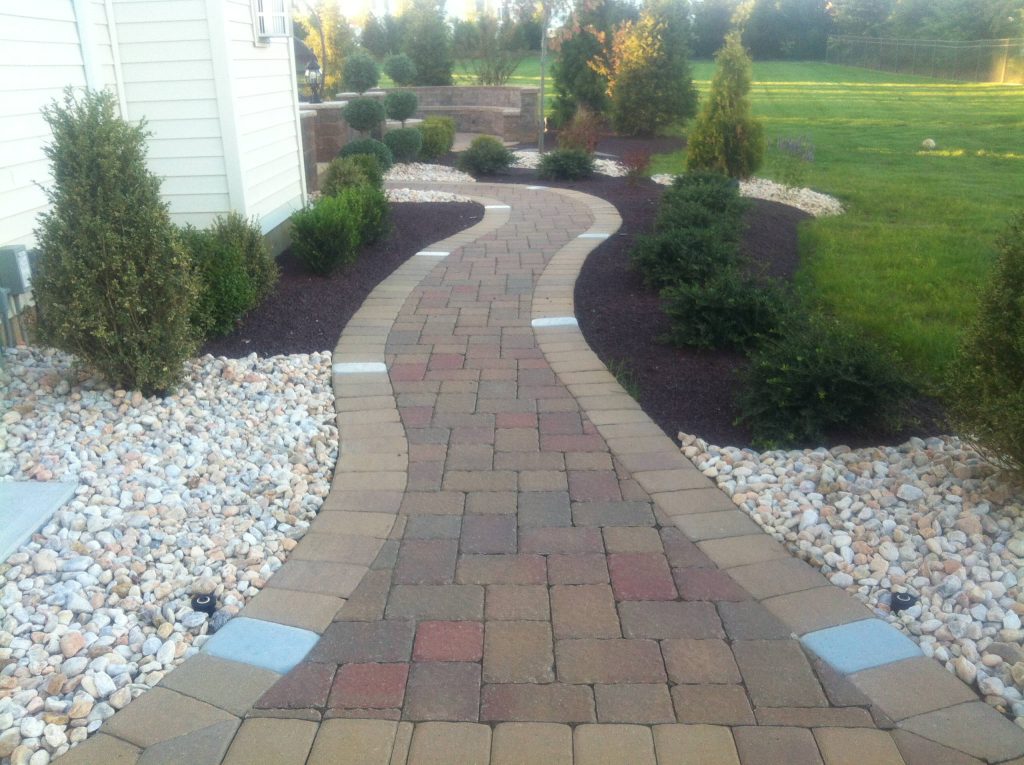 This is an example of a front yard brick landscaping in New York. by Paradise Stone & Tile | Outdoor Photos | Porch | Landscaping | Landscape Design | Outdoor Living Space | Porch Design Ideas | Outdoor Living Space Ideas | Backyard Design