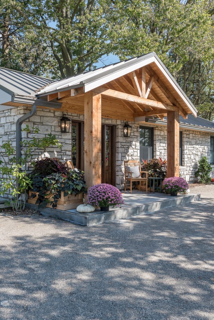 This is an example of a large country concrete porch design in Other with a roof extension. by Anderson & Rodgers Construction | Outdoor Photos | Porch | Landscaping | Landscape Design | Outdoor Living Space | Porch Design Ideas | Outdoor Living Space Ideas | Backyard Design