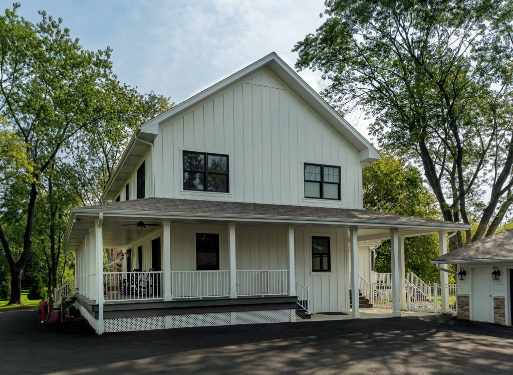 This is an example of a large farmhouse wood railing porch design in Chicago with decking and a roof extension. by 12/12 Architects & Planners | Outdoor Photos | Porch | Landscaping | Landscape Design | Outdoor Living Space | Porch Design Ideas | Outdoor Living Space Ideas | Backyard Design