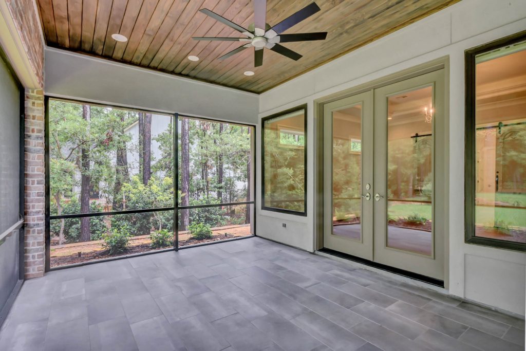 This is an example of a large french country tile screened-in back porch design in Houston with a roof extension. by Wyrick Residential Design | Outdoor Photos | Porch | Landscaping | Landscape Design | Outdoor Living Space | Porch Design Ideas | Outdoor Living Space Ideas | Backyard Design