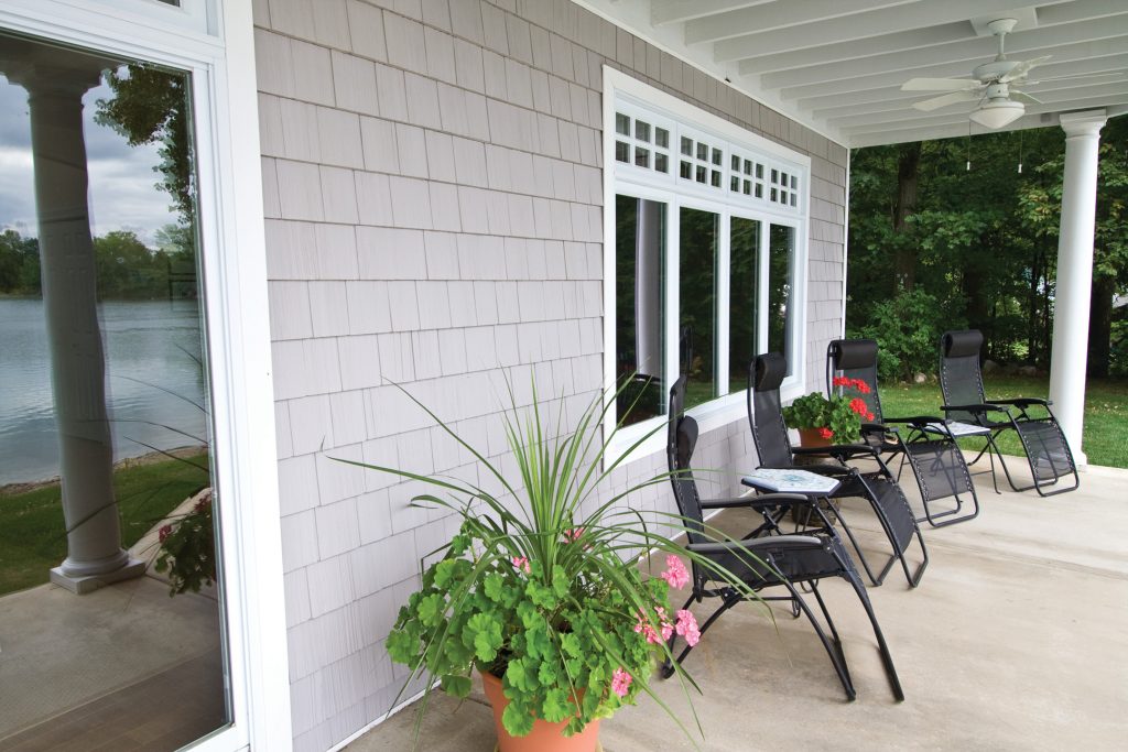 This is an example of a large front porch design in Burlington with a roof extension. by Ron Roy's New View | Outdoor Photos | Porch | Landscaping | Landscape Design | Outdoor Living Space | Porch Design Ideas | Outdoor Living Space Ideas | Backyard Design