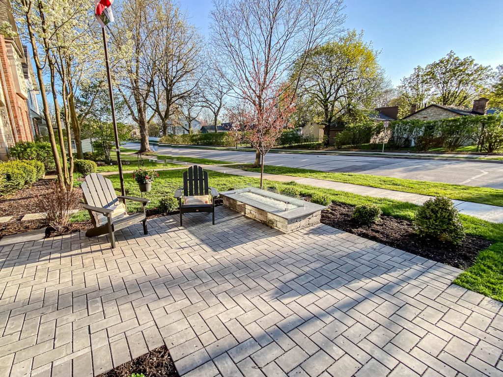 This is an example of a large industrial brick front porch design in Chicago with a fire pit. by DJK Custom Homes | Outdoor Photos | Porch | Landscaping | Landscape Design | Outdoor Living Space | Porch Design Ideas | Outdoor Living Space Ideas | Backyard Design