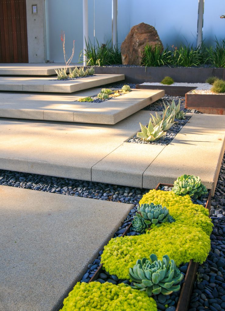 This is an example of a large modern drought-tolerant and partial sun backyard concrete paver garden path in San Diego.