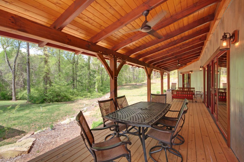This is an example of a large rustic back porch design in Other with a roof extension. by MoreSun Timber Frames | Outdoor Photos | Porch | Landscaping | Landscape Design | Outdoor Living Space | Porch Design Ideas | Outdoor Living Space Ideas | Backyard Design