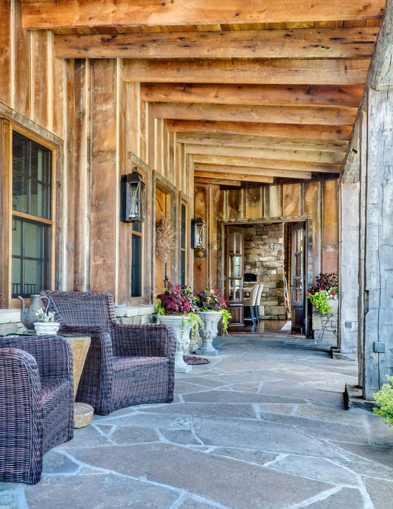 This is an example of a large rustic stone back porch design in Other with a roof extension. by KA Architecture | Outdoor Photos | Porch | Landscaping | Landscape Design | Outdoor Living Space | Porch Design Ideas | Outdoor Living Space Ideas | Backyard Design
