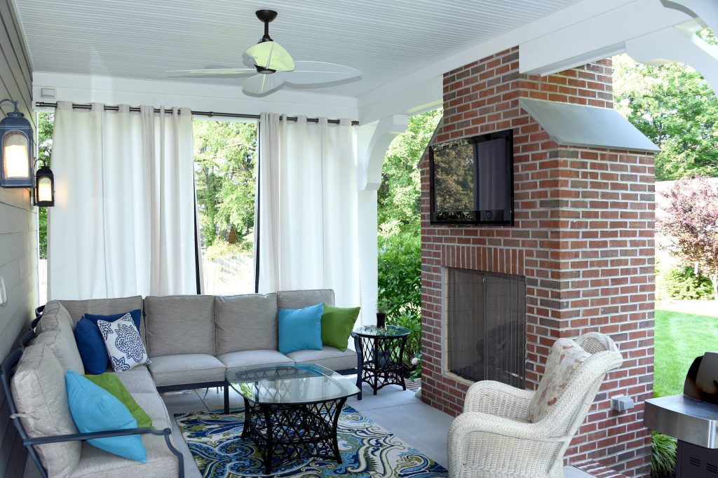 This is an example of a large traditional concrete back porch design in Philadelphia with a fire pit and a roof extension. by Holliday Architects | Outdoor Photos | Porch | Landscaping | Landscape Design | Outdoor Living Space | Porch Design Ideas | Outdoor Living Space Ideas | Backyard Design