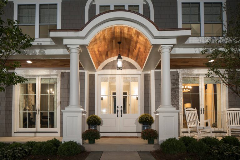 This is an example of a large traditional concrete front porch design in Chicago with a roof extension. by Homes by Pinnacle, Inc. | Outdoor Photos | Porch | Landscaping | Landscape Design | Outdoor Living Space | Porch Design Ideas | Outdoor Living Space Ideas | Backyard Design