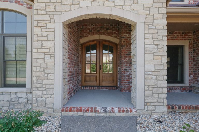 This is an example of a large traditional concrete front porch design in St Louis with a roof extension. by Premier Homes by Jones | Outdoor Photos | Porch | Landscaping | Landscape Design | Outdoor Living Space | Porch Design Ideas | Outdoor Living Space Ideas | Backyard Design