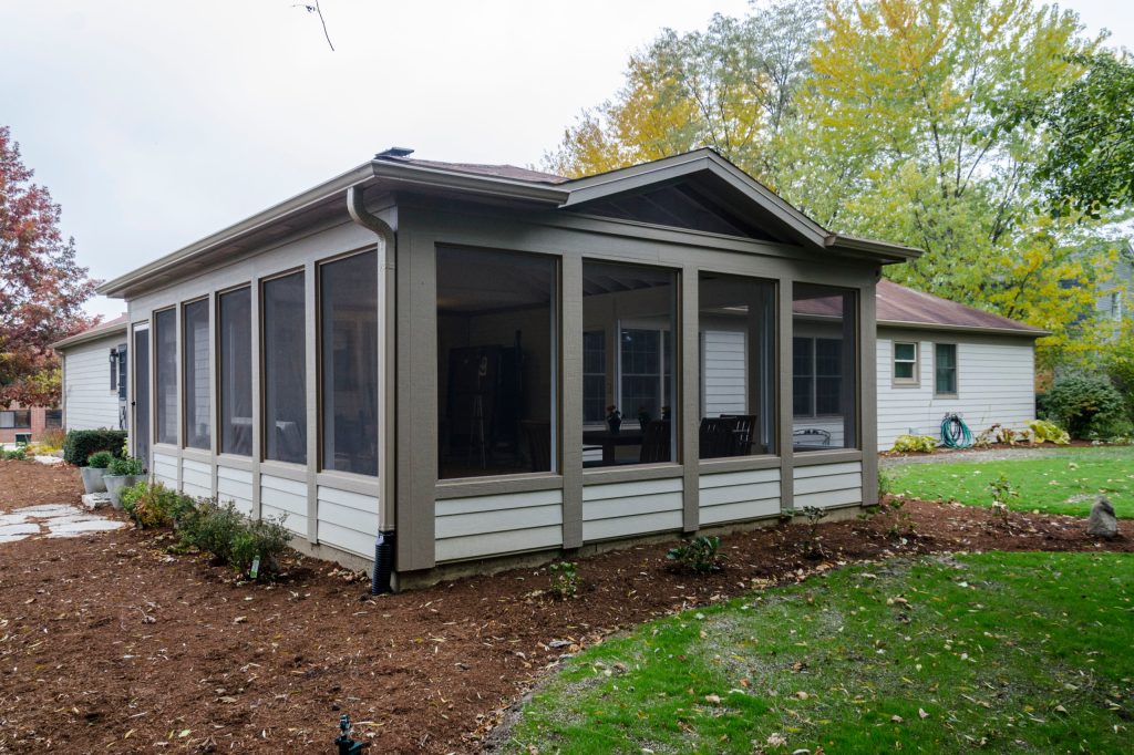 This is an example of a large traditional concrete screened-in back porch design in Chicago with a roof extension. by Synergy Builders Inc. | Outdoor Photos | Porch | Landscaping | Landscape Design | Outdoor Living Space | Porch Design Ideas | Outdoor Living Space Ideas | Backyard Design