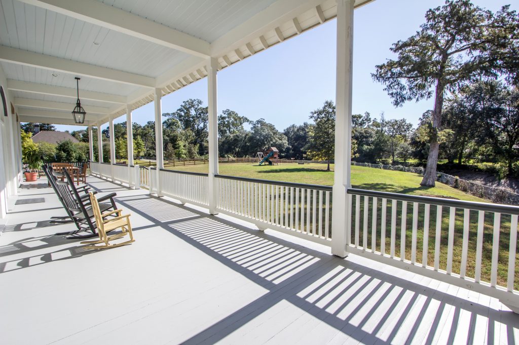 This is an example of a large traditional front porch design in New Orleans with a roof extension. by Braniff Construction | Outdoor Photos | Porch | Landscaping | Landscape Design | Outdoor Living Space | Porch Design Ideas | Outdoor Living Space Ideas | Backyard Design