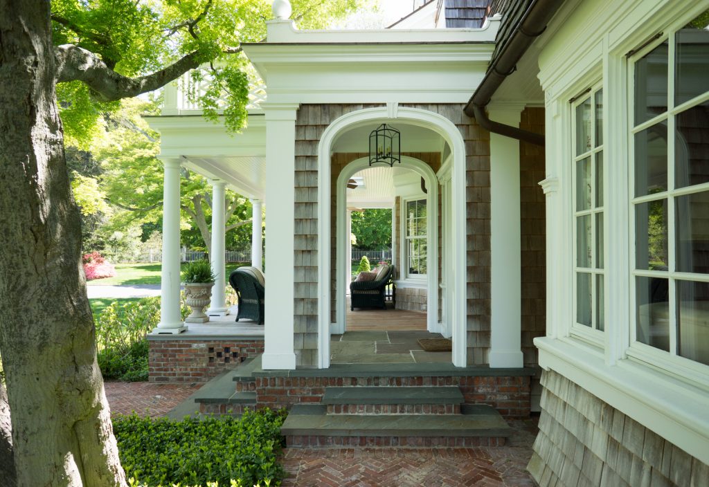 This is an example of a large traditional stone front porch design in New York with a roof extension. by Castro StoneWorks NY - Masonry Contractors | Outdoor Photos | Porch | Landscaping | Landscape Design | Outdoor Living Space | Porch Design Ideas | Outdoor Living Space Ideas | Backyard Design