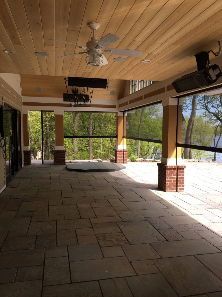 This is an example of a large transitional stone back porch design in Minneapolis with a roof extension. by Minnesota Screens | Outdoor Photos | Porch | Landscaping | Landscape Design | Outdoor Living Space | Porch Design Ideas | Outdoor Living Space Ideas | Backyard Design