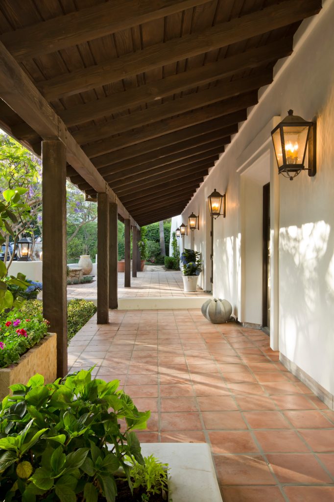 This is an example of a mediterranean tile front porch design in Los Angeles with a roof extension. by Domani Architecture + Planning Inc. | Outdoor Photos | Porch | Landscaping | Landscape Design | Outdoor Living Space | Porch Design Ideas | Outdoor Living Space Ideas | Backyard Design