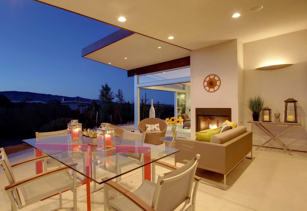 This is an example of a mid-sized 1950s concrete side porch design in Los Angeles with a fire pit and a roof extension. by Moderne Builders | Outdoor Photos | Porch | Landscaping | Landscape Design | Outdoor Living Space | Porch Design Ideas | Outdoor Living Space Ideas | Backyard Design