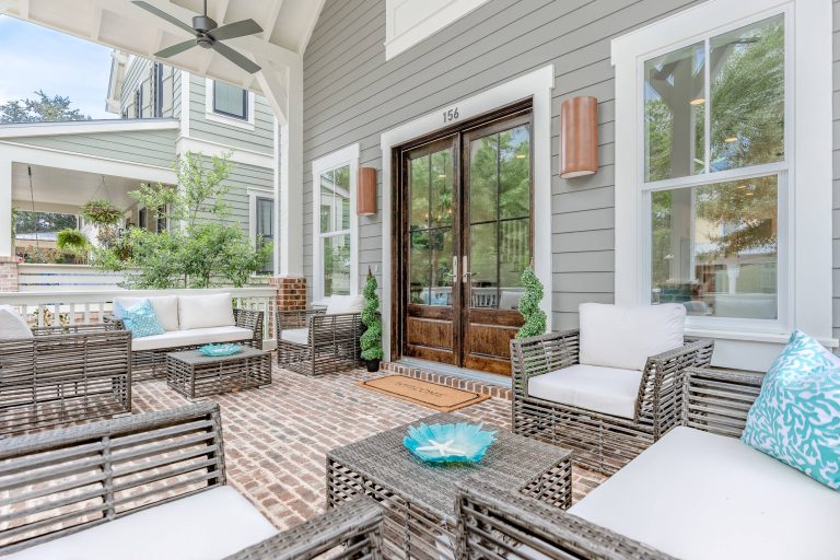 This is an example of a mid-sized coastal brick back porch design in Other with a roof extension. by Design and Dwell Homes LLC | Outdoor Photos | Porch | Landscaping | Landscape Design | Outdoor Living Space | Porch Design Ideas | Outdoor Living Space Ideas | Backyard Design