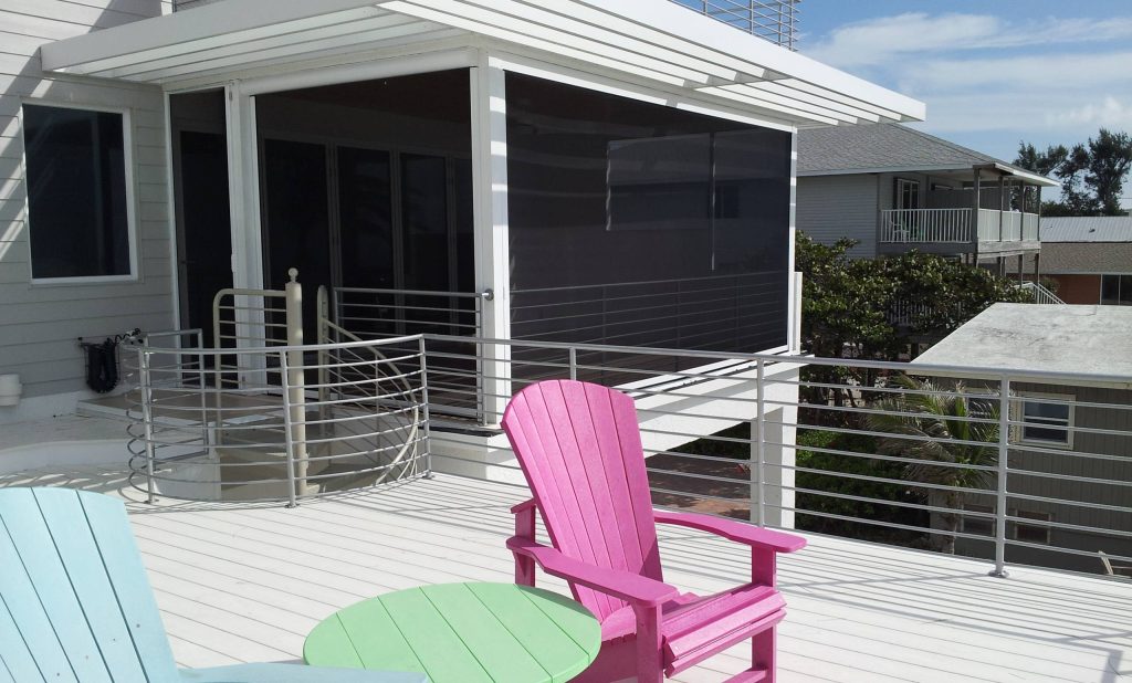 This is an example of a mid-sized coastal screened-in back porch design in Tampa with a roof extension. by Gulf Coast Retractable Screens Inc | Outdoor Photos | Porch | Landscaping | Landscape Design | Outdoor Living Space | Porch Design Ideas | Outdoor Living Space Ideas | Backyard Design