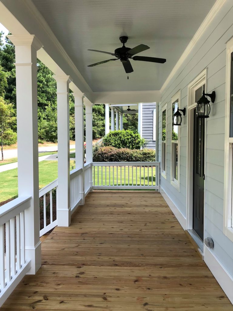 This is an example of a mid-sized cottage front porch design in Atlanta with decking and a roof extension. by UpperTown Homes | Outdoor Photos | Porch | Landscaping | Landscape Design | Outdoor Living Space | Porch Design Ideas | Outdoor Living Space Ideas | Backyard Design