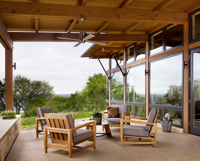 This is an example of a mid-sized country tile side porch design in Austin with a roof extension. by Ashby Collective | Outdoor Photos | Porch | Landscaping | Landscape Design | Outdoor Living Space | Porch Design Ideas | Outdoor Living Space Ideas | Backyard Design