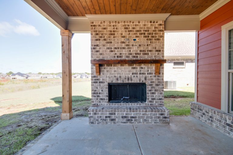 This is an example of a mid-sized craftsman concrete back porch design in Nashville with a fireplace and a roof extension. by Holmes by Design | Outdoor Photos | Porch | Landscaping | Landscape Design | Outdoor Living Space | Porch Design Ideas | Outdoor Living Space Ideas | Backyard Design
