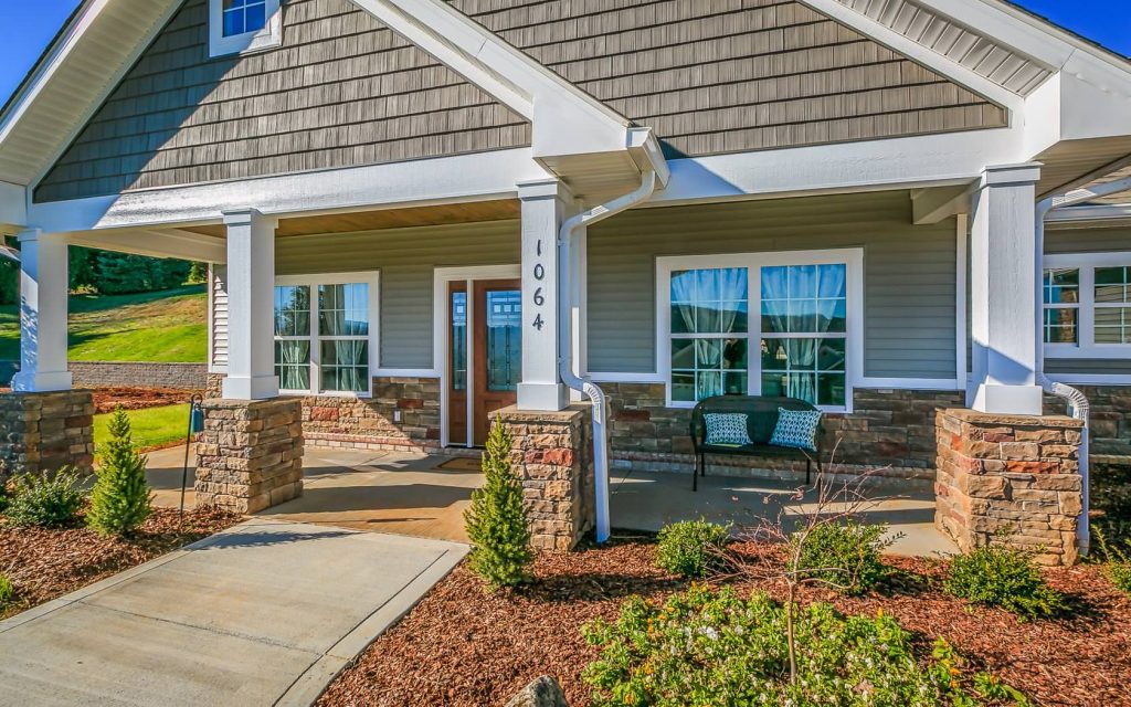 This is an example of a mid-sized craftsman stone back porch design in Other with a roof extension. by Jeff Spear Homes | Outdoor Photos | Porch | Landscaping | Landscape Design | Outdoor Living Space | Porch Design Ideas | Outdoor Living Space Ideas | Backyard Design