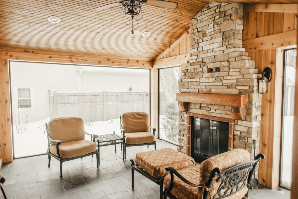 This is an example of a mid-sized craftsman tile back porch design in Minneapolis with a fireplace and a roof extension. by Niedfeldt Home Remodeling | Outdoor Photos | Porch | Landscaping | Landscape Design | Outdoor Living Space | Porch Design Ideas | Outdoor Living Space Ideas | Backyard Design