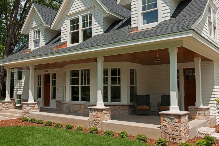 This is an example of a mid-sized front porch design in Minneapolis with a roof extension. by OSLO Builders | Outdoor Photos | Porch | Landscaping | Landscape Design | Outdoor Living Space | Porch Design Ideas | Outdoor Living Space Ideas | Backyard Design