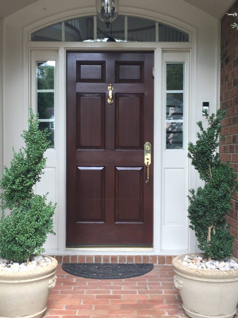 This is an example of a mid-sized traditional brick front porch design in Raleigh with a roof extension. by Southern Custom Doors | Outdoor Photos | Porch | Landscaping | Landscape Design | Outdoor Living Space | Porch Design Ideas | Outdoor Living Space Ideas | Backyard Design