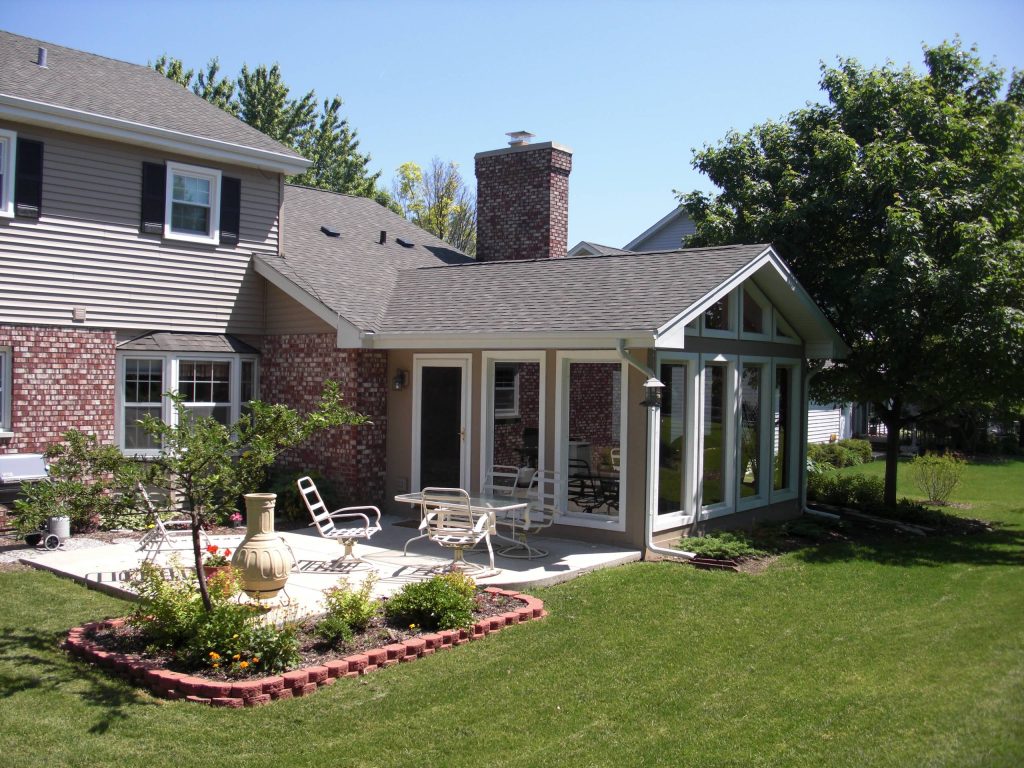 This is an example of a mid-sized traditional concrete porch design in Chicago with a roof extension. by Apex Builders, Inc. | Outdoor Photos | Porch | Landscaping | Landscape Design | Outdoor Living Space | Porch Design Ideas | Outdoor Living Space Ideas | Backyard Design
