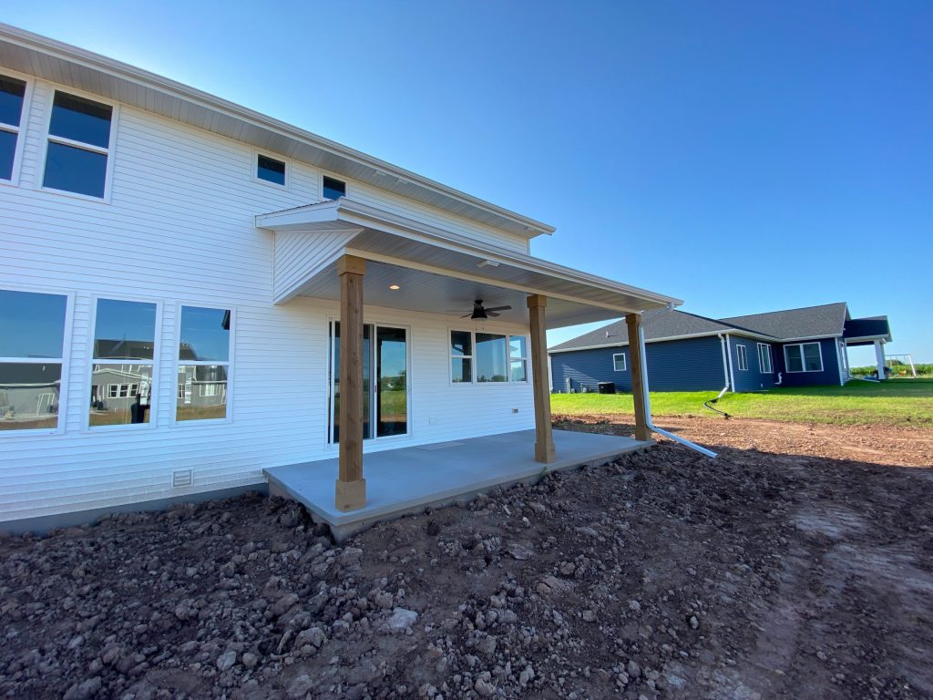This is an example of a mid-sized traditional concrete porch design in Other with a roof extension. by Cypress Homes, Inc. | Outdoor Photos | Porch | Landscaping | Landscape Design | Outdoor Living Space | Porch Design Ideas | Outdoor Living Space Ideas | Backyard Design