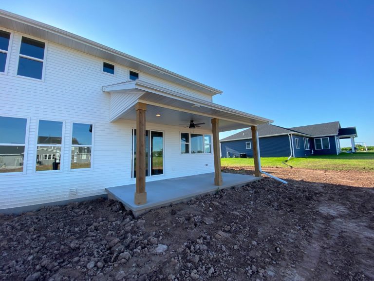 This is an example of a mid-sized traditional concrete porch design in Other with a roof extension. by Cypress Homes, Inc. | Outdoor Photos | Porch | Landscaping | Landscape Design | Outdoor Living Space | Porch Design Ideas | Outdoor Living Space Ideas | Backyard Design