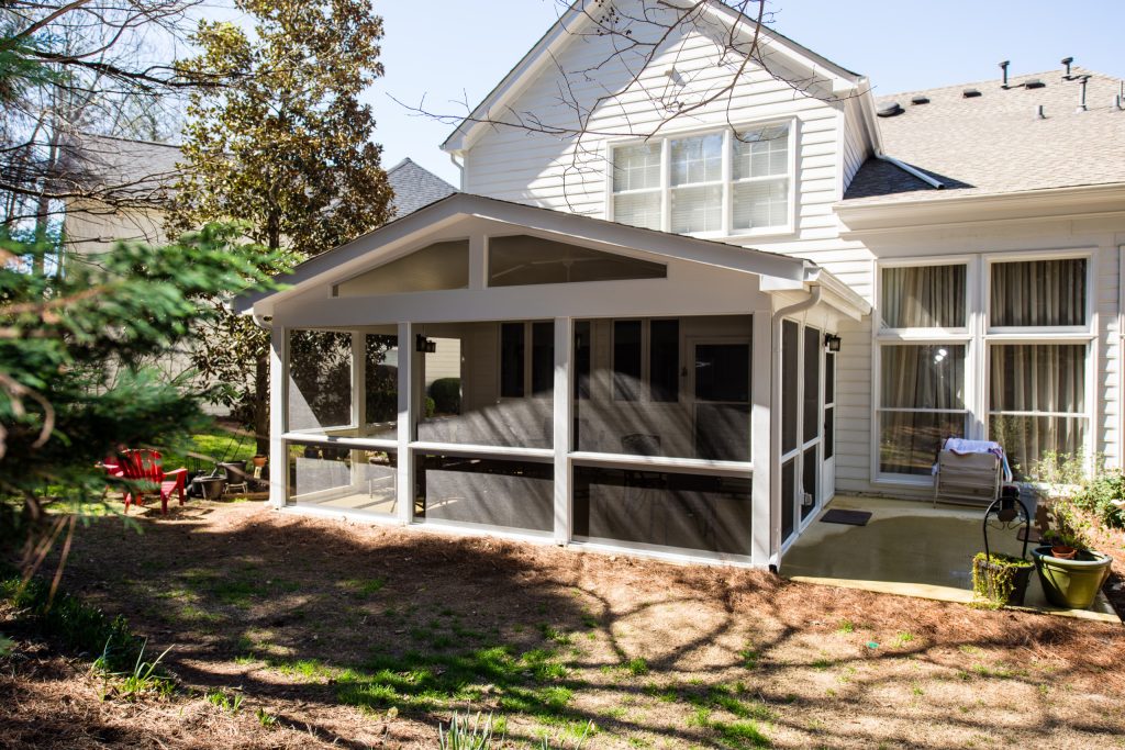 This is an example of a mid-sized traditional screened-in back porch design in Atlanta with a roof extension. by Synergy Outdoor | Outdoor Photos | Porch | Landscaping | Landscape Design | Outdoor Living Space | Porch Design Ideas | Outdoor Living Space Ideas | Backyard Design