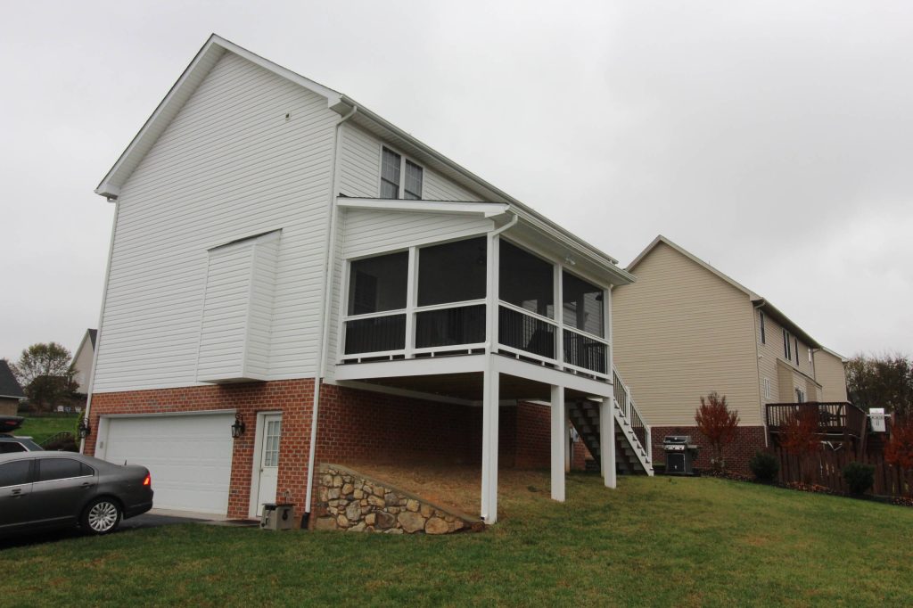 This is an example of a mid-sized traditional screened-in back porch design in Other with a roof extension. by Construction Marketing, LLC | Outdoor Photos | Porch | Landscaping | Landscape Design | Outdoor Living Space | Porch Design Ideas | Outdoor Living Space Ideas | Backyard Design