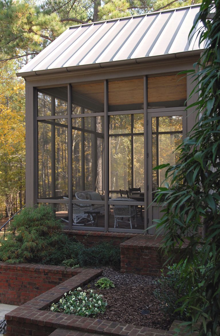 This is an example of a mid-sized traditional screened-in side porch design in Other with a roof extension. by Looney Ricks Kiss | Outdoor Photos | Porch | Landscaping | Landscape Design | Outdoor Living Space | Porch Design Ideas | Outdoor Living Space Ideas | Backyard Design