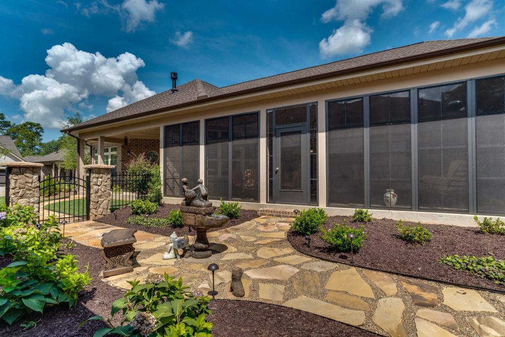 This is an example of a mid-sized traditional stone screened-in back porch design in Charlotte with a roof extension. by NewStyle Communities | Outdoor Photos | Porch | Landscaping | Landscape Design | Outdoor Living Space | Porch Design Ideas | Outdoor Living Space Ideas | Backyard Design
