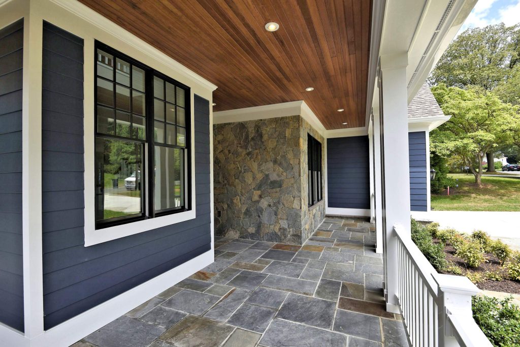 This is an example of a mid-sized transitional stone front porch design in DC Metro with a roof extension. by Mid-Atlantic Custom Builders | Outdoor Photos | Porch | Landscaping | Landscape Design | Outdoor Living Space | Porch Design Ideas | Outdoor Living Space Ideas | Backyard Design