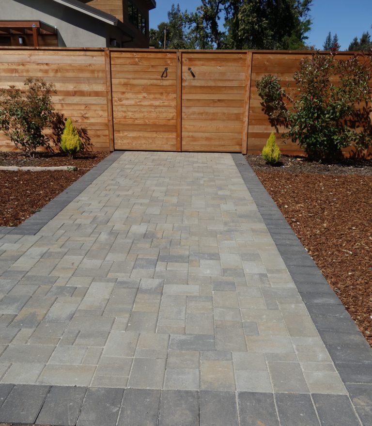 This is an example of a mid-sized modern drought-tolerant and full sun backyard brick landscaping in San Francisco.