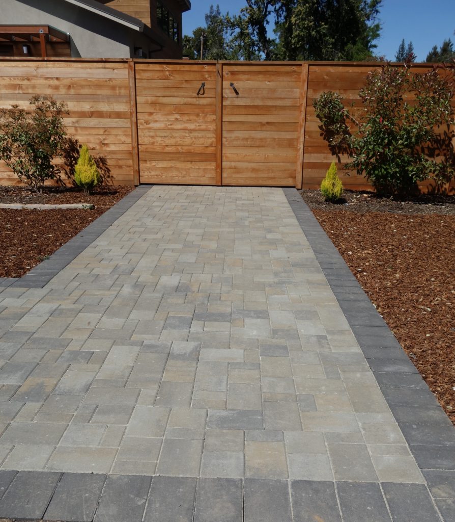 This is an example of a mid-sized modern drought-tolerant and full sun backyard brick landscaping in San Francisco.