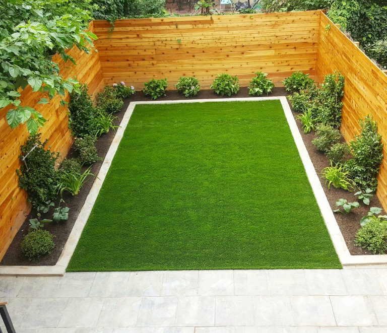 This is an example of a mid-sized modern full sun backyard concrete paver landscaping in New York.