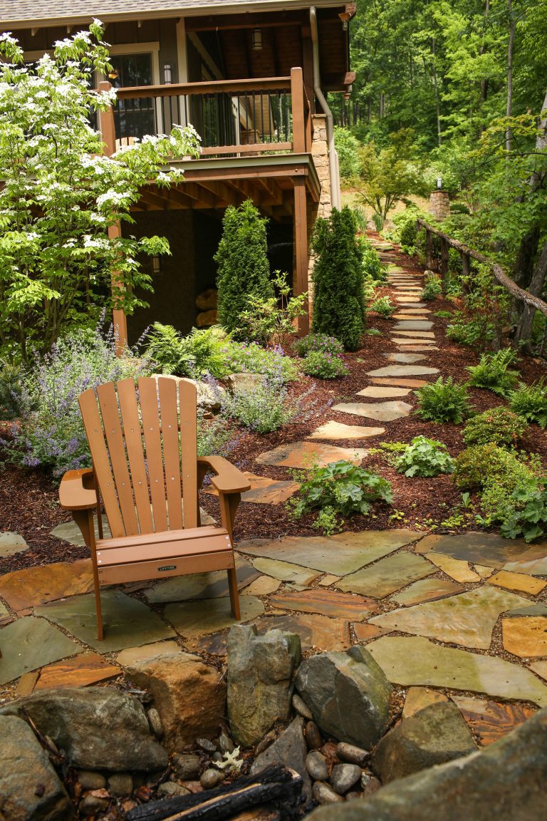 This is an example of a mid-sized rustic shade backyard stone garden path in Charlotte for summer.