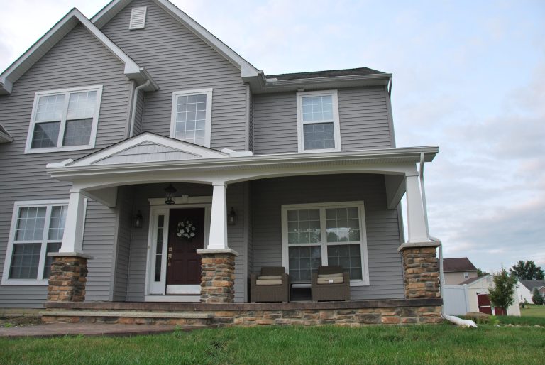 This is an example of a modern brick front porch design in Cleveland with a roof extension. by DeckCreator | Outdoor Photos | Porch | Landscaping | Landscape Design | Outdoor Living Space | Porch Design Ideas | Outdoor Living Space Ideas | Backyard Design
