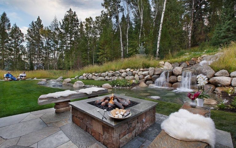 This is an example of a rustic backyard landscaping in Other with a fire pit.