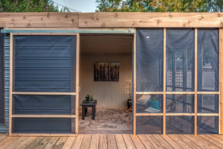This is an example of a rustic screened-in back porch design in Austin with decking and a roof extension. by Amy Baez Interiors | Outdoor Photos | Porch | Landscaping | Landscape Design | Outdoor Living Space | Porch Design Ideas | Outdoor Living Space Ideas | Backyard Design