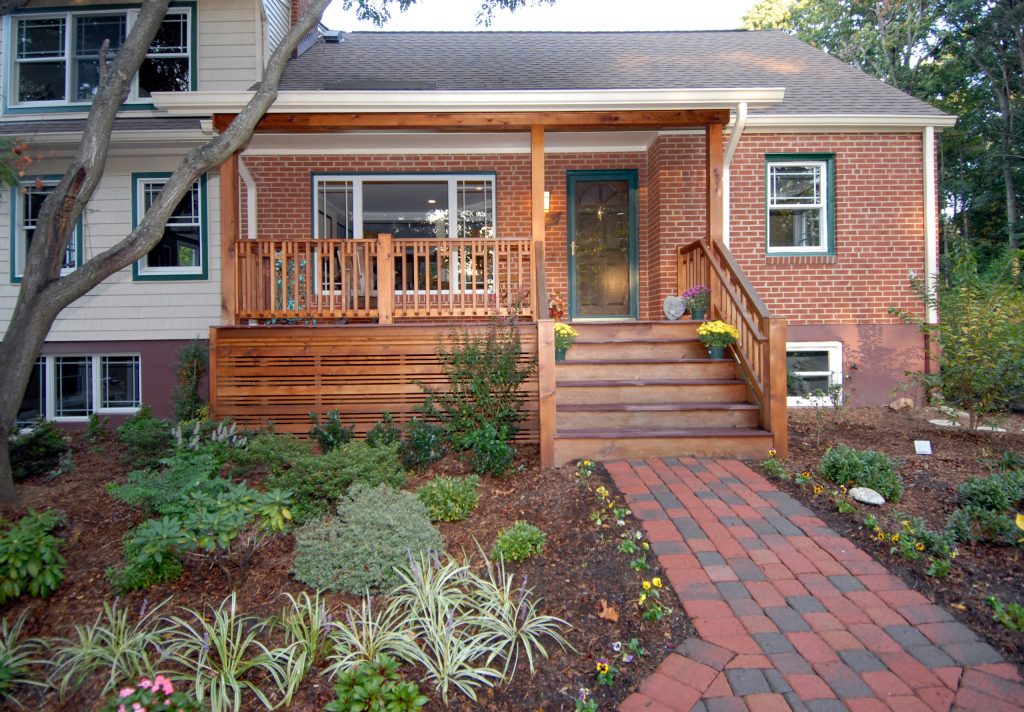 This is an example of a small craftsman brick front porch design in DC Metro with a roof extension. by Schroeder Design/Build, Inc. | Outdoor Photos | Porch | Landscaping | Landscape Design | Outdoor Living Space | Porch Design Ideas | Outdoor Living Space Ideas | Backyard Design