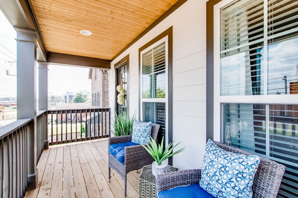 This is an example of a small traditional wood railing front porch design in Nashville with a roof extension. by McSwain Interior Designs | Outdoor Photos | Porch | Landscaping | Landscape Design | Outdoor Living Space | Porch Design Ideas | Outdoor Living Space Ideas | Backyard Design