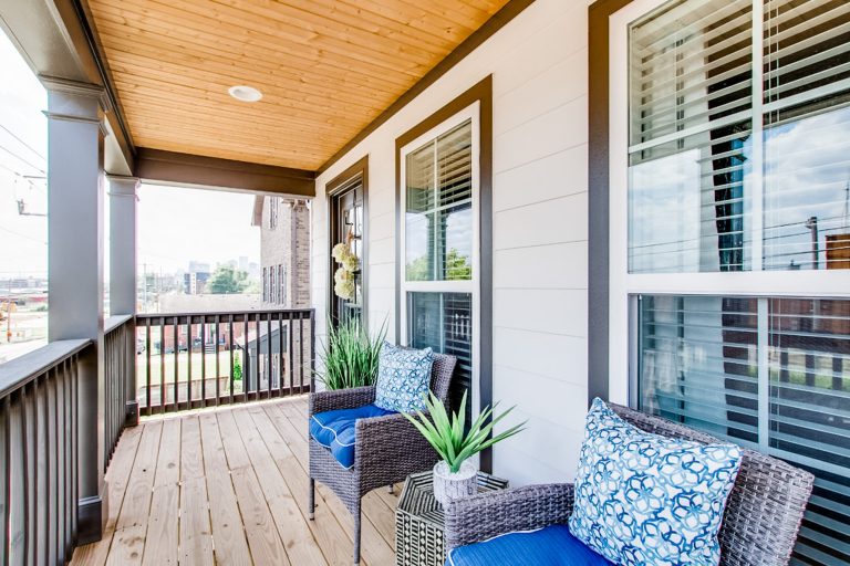 This is an example of a small traditional wood railing front porch design in Nashville with a roof extension. by McSwain Interior Designs | Outdoor Photos | Porch | Landscaping | Landscape Design | Outdoor Living Space | Porch Design Ideas | Outdoor Living Space Ideas | Backyard Design