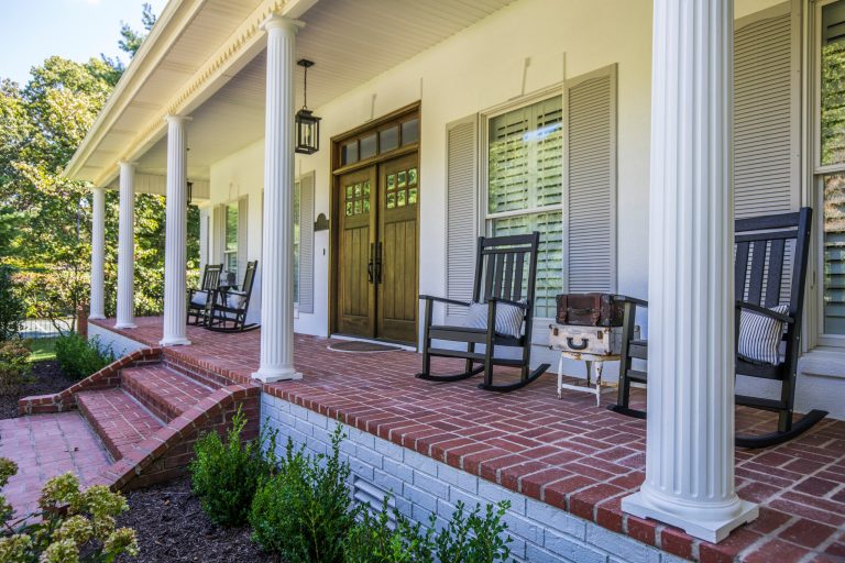 This is an example of a traditional brick front porch design in Other with a roof extension. by Nico Interior Design | Outdoor Photos | Porch | Landscaping | Landscape Design | Outdoor Living Space | Porch Design Ideas | Outdoor Living Space Ideas | Backyard Design