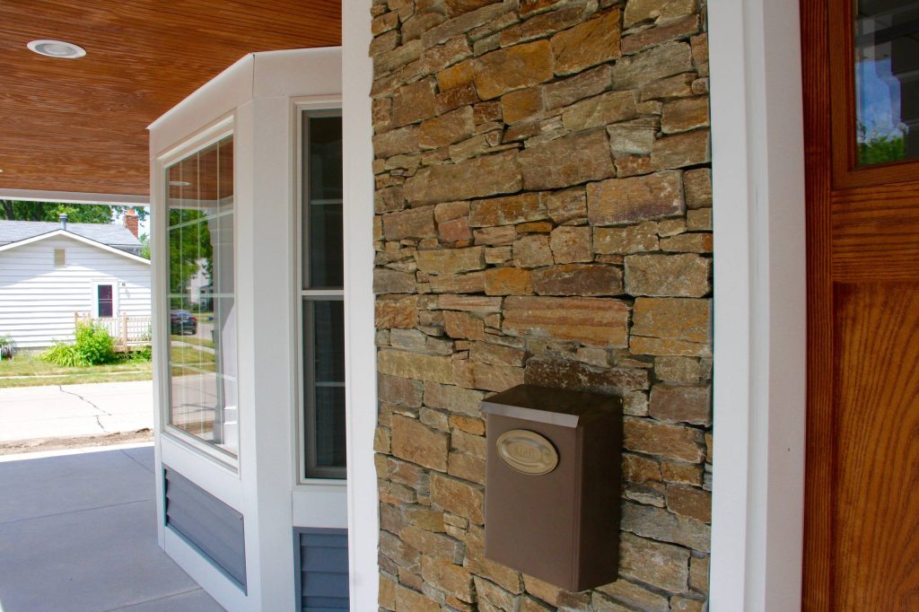 This is an example of a traditional concrete front porch design in Detroit with a roof extension. by Oliver Construction, Inc. | Outdoor Photos | Porch | Landscaping | Landscape Design | Outdoor Living Space | Porch Design Ideas | Outdoor Living Space Ideas | Backyard Design