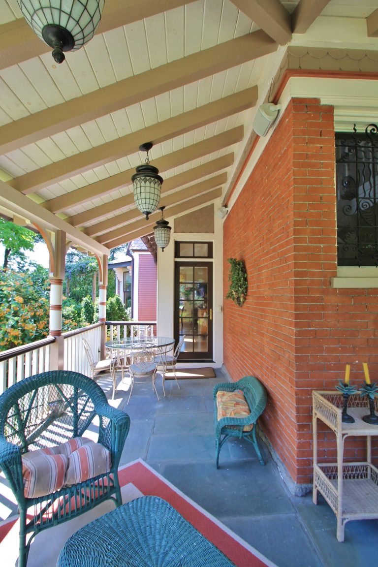 This is an example of a traditional concrete front porch design in Philadelphia with a roof extension. by Custom Woodcraft Inc. | Outdoor Photos | Porch | Landscaping | Landscape Design | Outdoor Living Space | Porch Design Ideas | Outdoor Living Space Ideas | Backyard Design