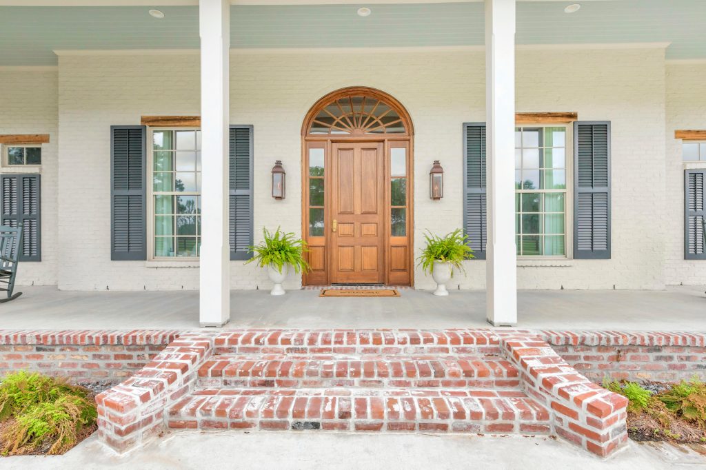 This is an example of a traditional porch design in New Orleans. by At Home | Outdoor Photos | Porch | Landscaping | Landscape Design | Outdoor Living Space | Porch Design Ideas | Outdoor Living Space Ideas | Backyard Design