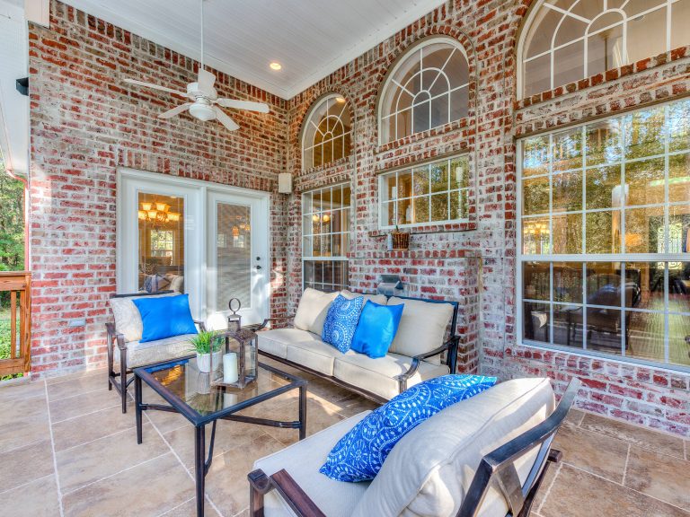 This is an example of a traditional porch design in Other with a roof extension. by Showhomes Mobile/Baldwin | Outdoor Photos | Porch | Landscaping | Landscape Design | Outdoor Living Space | Porch Design Ideas | Outdoor Living Space Ideas | Backyard Design